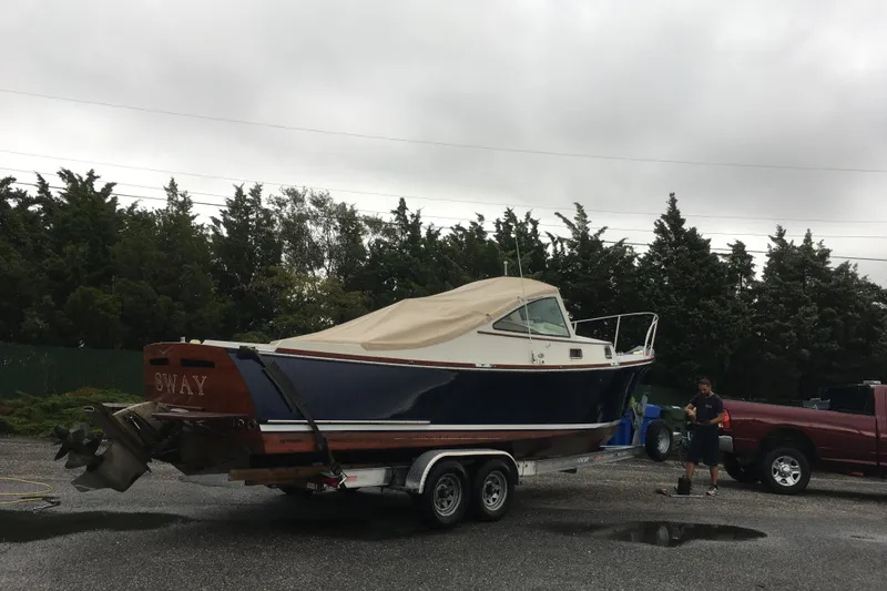Slide: The Image of 2009 Landing School Arrundel 27 boat on trailer, covered, with overcast sky. - 20