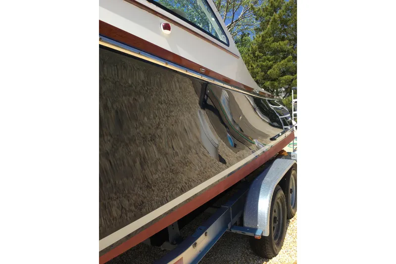 Slide: The Image of 2009 Landing School Arrundel 27 boat on trailer, reflecting surroundings. - 23