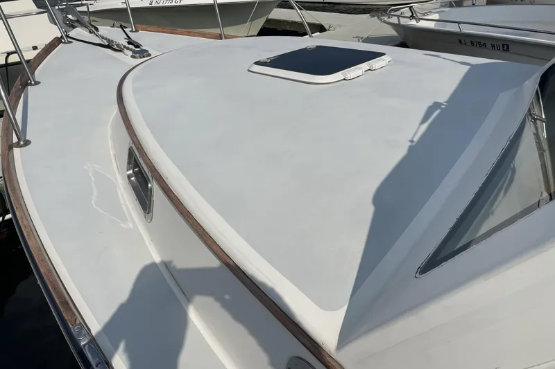 Slide: The Image of 2009 Landing School Arrundel 27 boat deck with hatch and wooden trim. - 27