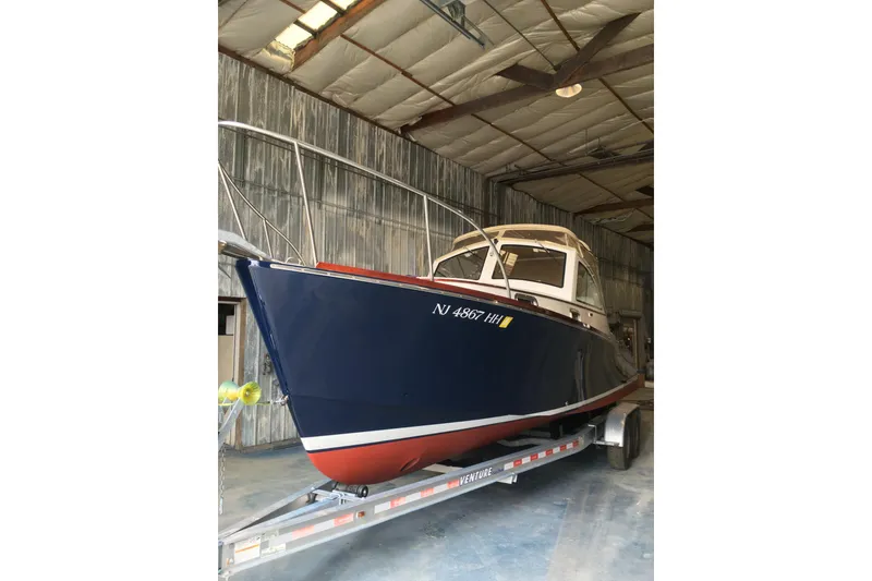 Slide: The Image of 2009 Landing School Arrundel 27 boat in a warehouse on a trailer. - 5