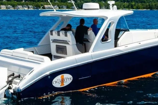 The Image of 2019 Cigarette 41' GTR boat cruising on a lake with passengers onboard. - 1