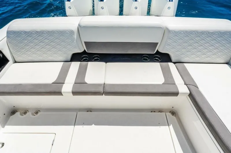 Slide: The Image of Luxury seating on 2019 Cigarette 41' GTR boat, featuring elegant upholstery and cup holders. - 10