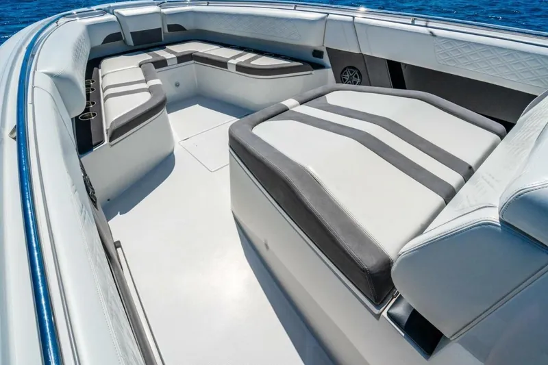 Slide: The Image of Luxurious seating on 2019 Cigarette 41' GTR boat, featuring sleek white and gray upholstery. - 20