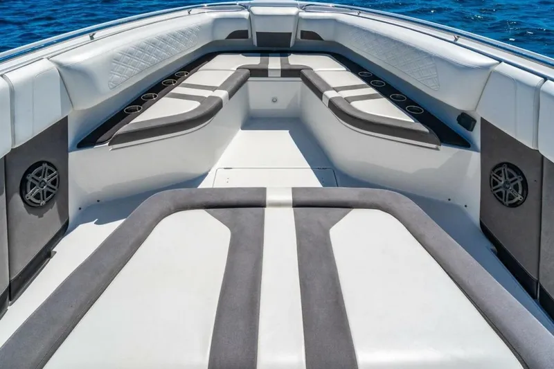Slide: The Image of 2019 Cigarette 41' GTR boat interior with cushioned seating and cup holders on open water. - 23