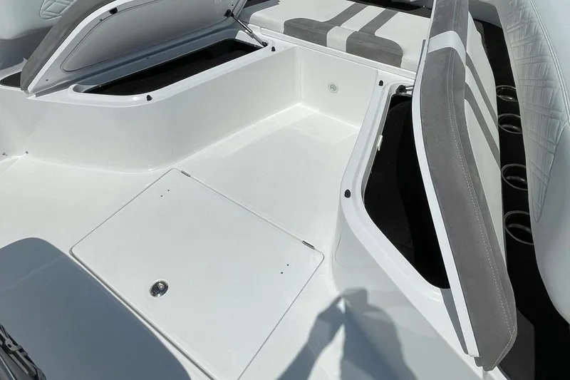Slide: The Image of 2019 Cigarette 41' GTR boat interior with open storage compartments and cushioned seating. - 25