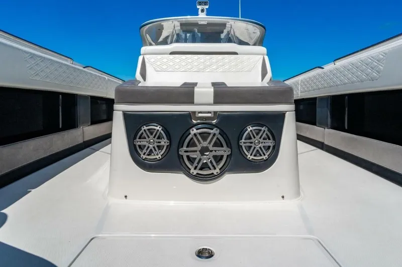 Slide: The Image of 2019 Cigarette 41' GTR boat interior with JL Audio speakers, sleek design, and blue sky backdrop. - 26
