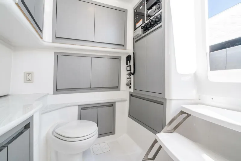 Slide: The Image of Interior of 2019 Cigarette 41' GTR boat featuring modern cabinetry and a compact toilet. - 28