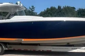 Slide: The Image of 2019 Cigarette 41' GTR boat on trailer, sleek design, blue and orange accents. - 3