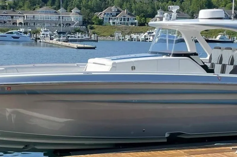 Slide: The Image of 2019 Cigarette 41' GTR boat docked in a scenic marina setting. - 4