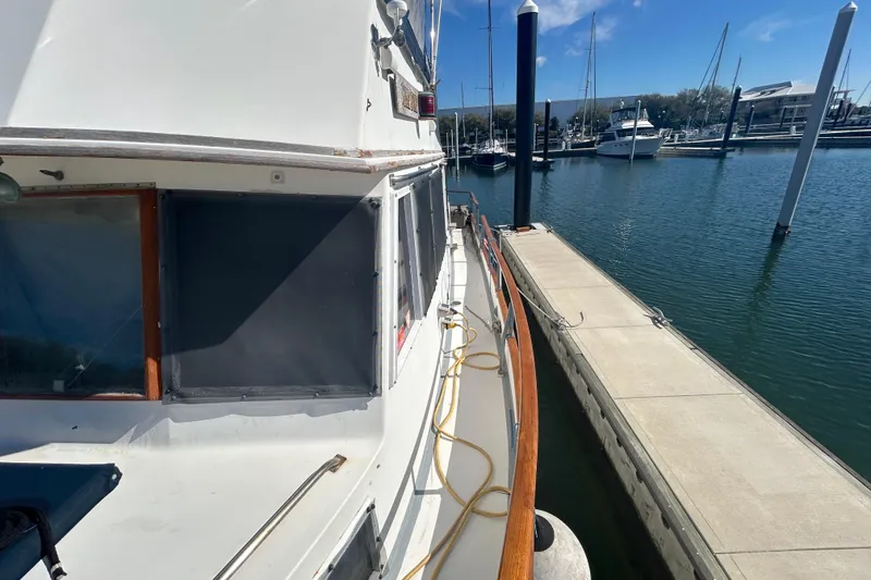 Slide: The Image of 1988 Grand Banks 36 Classic yacht docked at marina, side view. - 10
