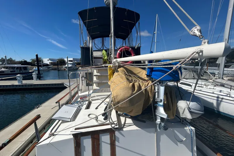 Slide: The Image of 1988 Grand Banks 36 Classic yacht docked at marina under clear blue sky. - 11