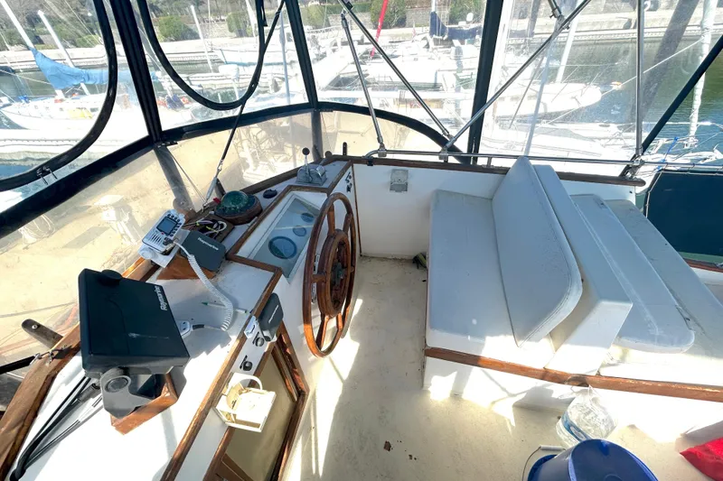 Slide: The Image of Cockpit of 1988 Grand Banks 36 Classic yacht with steering wheel and navigation equipment. - 15