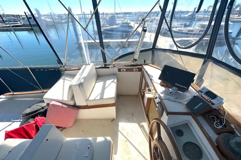 Slide: The Image of Flybridge of 1988 Grand Banks 36 Classic yacht with seating and navigation equipment. - 16