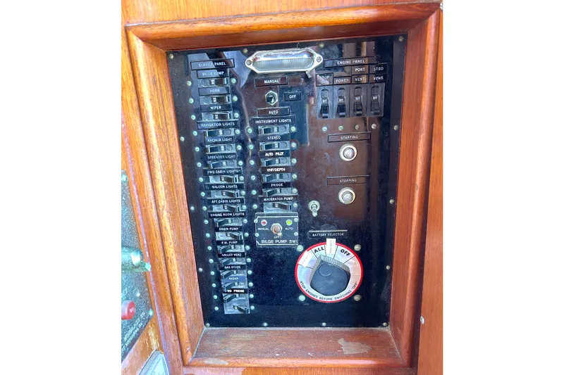 Slide: The Image of Control panel of a 1988 Grand Banks 36 Classic boat with various switches and dials. - 21