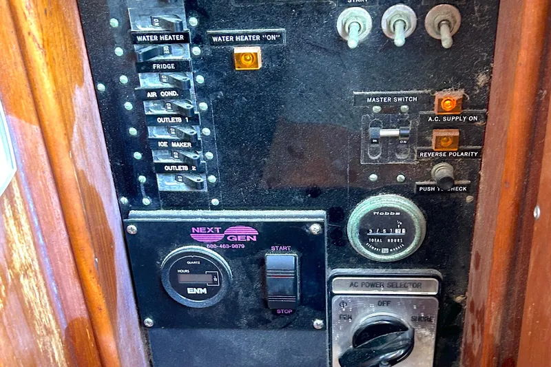 Slide: The Image of Electrical control panel of 1988 Grand Banks 36 Classic boat with switches and gauges. - 22