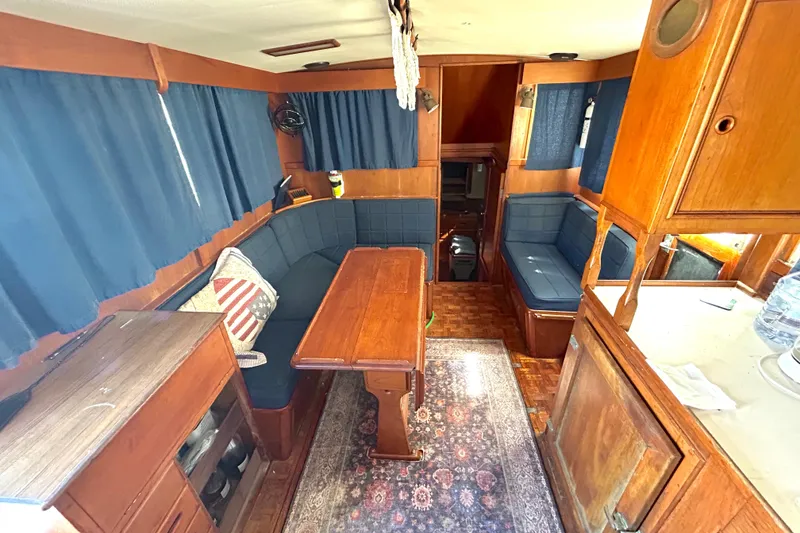 Slide: The Image of Interior of 1988 Grand Banks 36 Classic yacht with wooden furnishings and blue seating. - 23