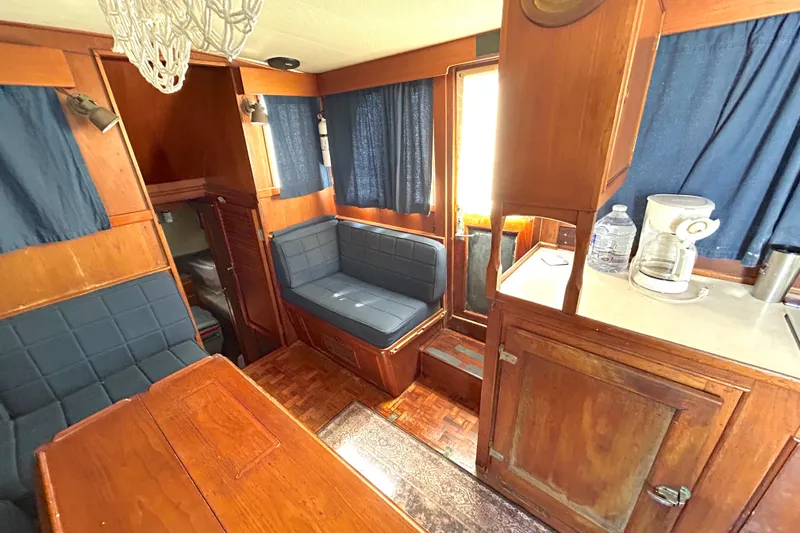 Slide: The Image of Interior of 1988 Grand Banks 36 Classic yacht with wood finish and blue upholstery. - 24
