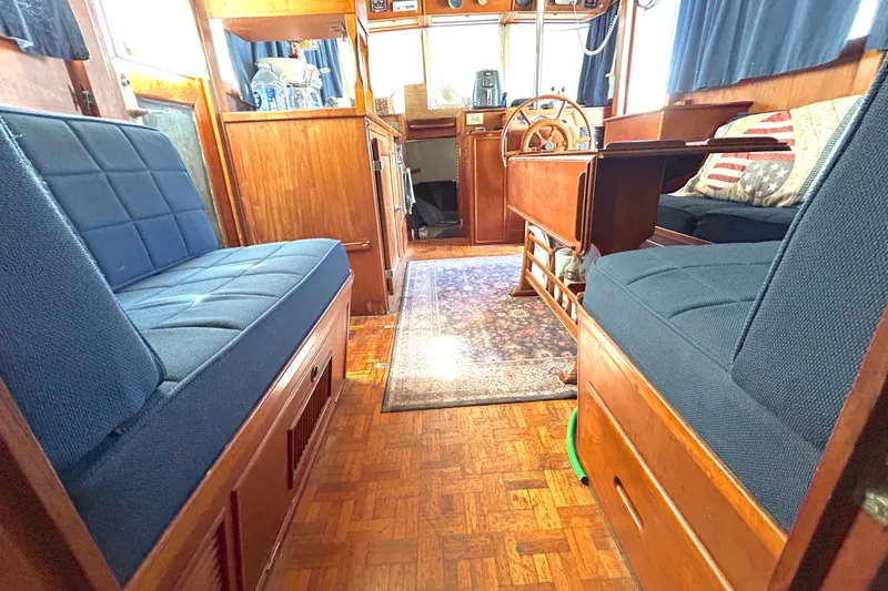 Slide: The Image of Interior of 1988 Grand Banks 36 Classic yacht with wooden furnishings and blue seating. - 27