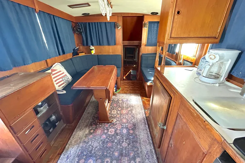 Slide: The Image of Interior of 1988 Grand Banks 36 Classic yacht with wooden furnishings and cozy seating area. - 29