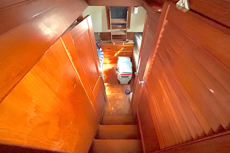Slide: The Image of Interior of 1988 Grand Banks 36 Classic, featuring wooden cabinetry and stairs. - 30