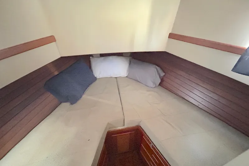 Slide: The Image of Cozy cabin interior of 1988 Grand Banks 36 Classic with pillows and wooden paneling. - 38