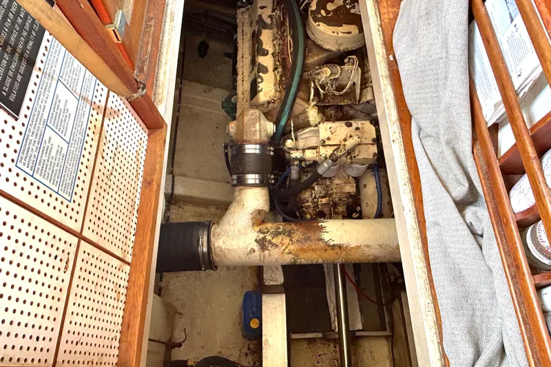 Slide: The Image of Engine compartment of 1988 Grand Banks 36 Classic boat, showing mechanical components and storage. - 43