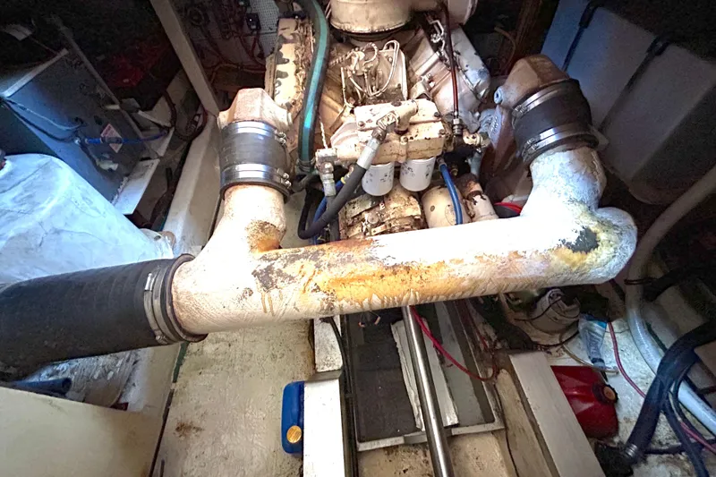 Slide: The Image of Engine room of 1988 Grand Banks 36 Classic, showing aged exhaust system and components. - 44