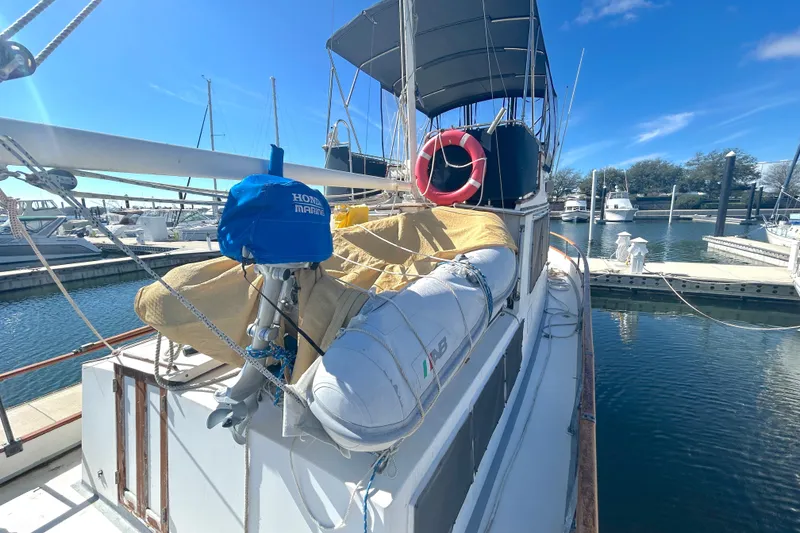 Slide: The Image of 1988 Grand Banks 36 Classic yacht docked, featuring a covered deck and lifebuoy. - 8