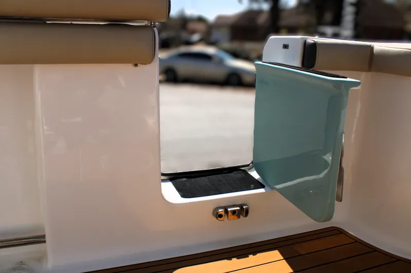 Slide: The Image of 2022 Tidewater 272 CC Adventure boat with open side door and teak flooring. - 14