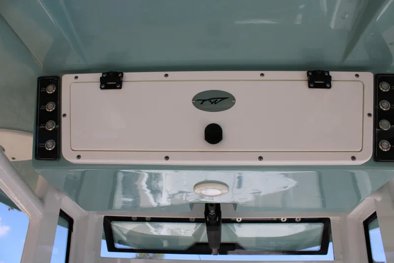 Slide: The Image of 2022 Tidewater 272 CC Adventure boat console with control panel and storage compartment. - 22