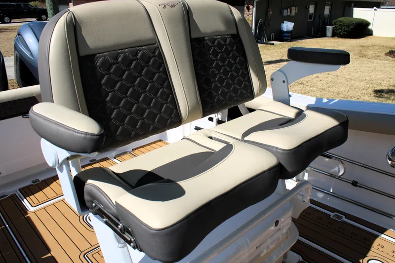 Slide: The Image of 2022 Tidewater 272 CC Adventure boat seats with stylish black and beige upholstery. - 23