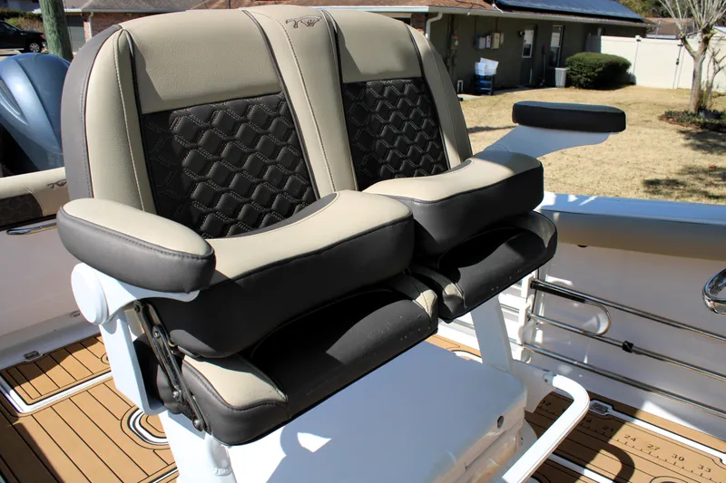Slide: The Image of 2022 Tidewater 272 CC Adventure boat seating with cushioned armrests and stylish design. - 24