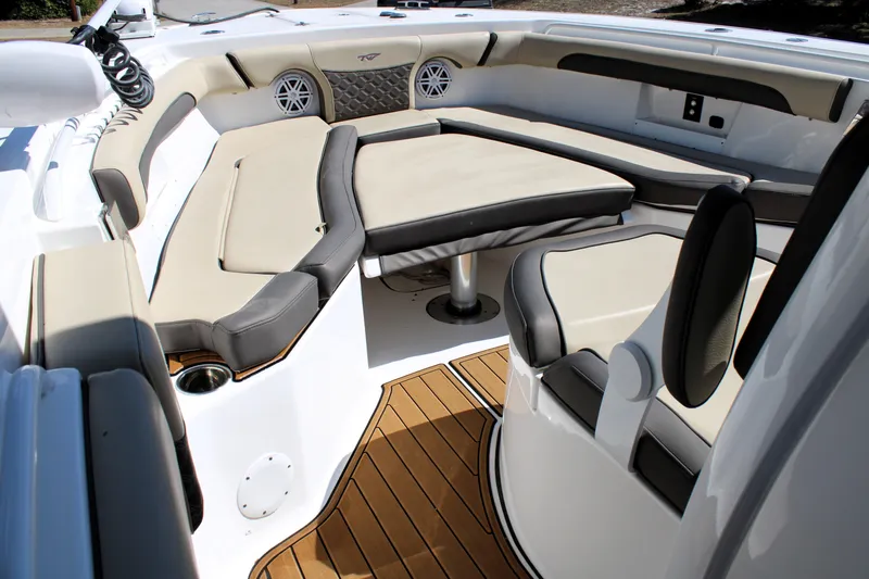 Slide: The Image of 2022 Tidewater 272 CC Adventure boat interior with cushioned seating and teak flooring. - 31