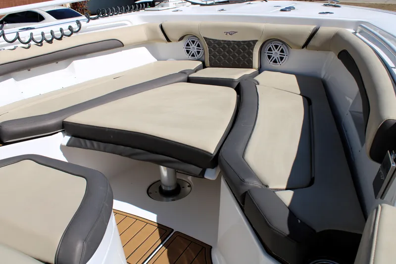 Slide: The Image of 2022 Tidewater 272 CC Adventure boat interior with cushioned seating and modern design. - 33