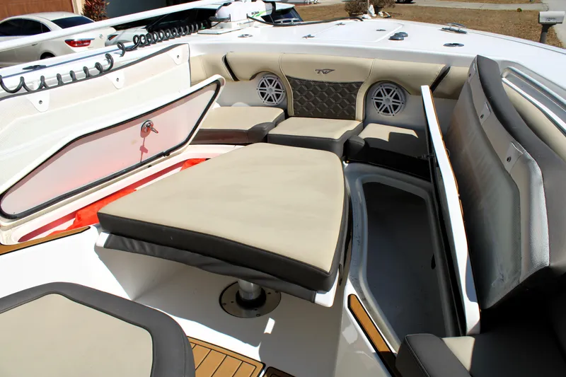 Slide: The Image of 2022 Tidewater 272 CC Adventure boat interior with cushioned seating and storage compartments. - 34