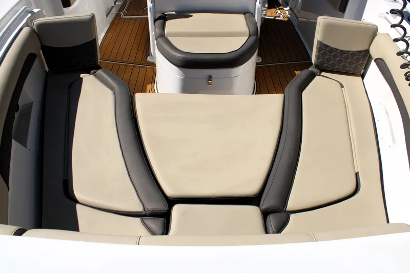 Slide: The Image of 2022 Tidewater 272 CC Adventure boat interior with cushioned seating and teak flooring. - 35