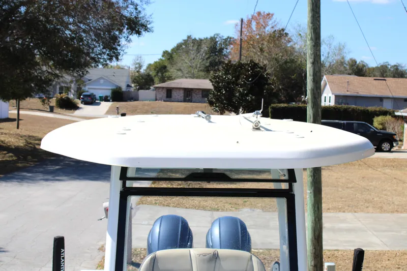 Slide: The Image of 2022 Tidewater 272 CC Adventure boat with T-top in a suburban setting. - 38