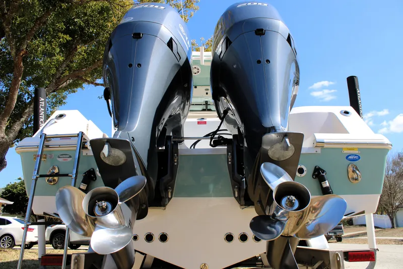 Slide: The Image of 2022 Tidewater 272 CC Adventure boat with dual outboard engines and stainless steel propellers. - 4