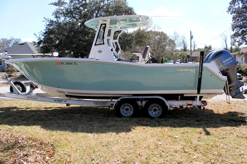 Slide: The Image of 2022 Tidewater 272 CC Adventure boat on trailer, parked outdoors. - 6
