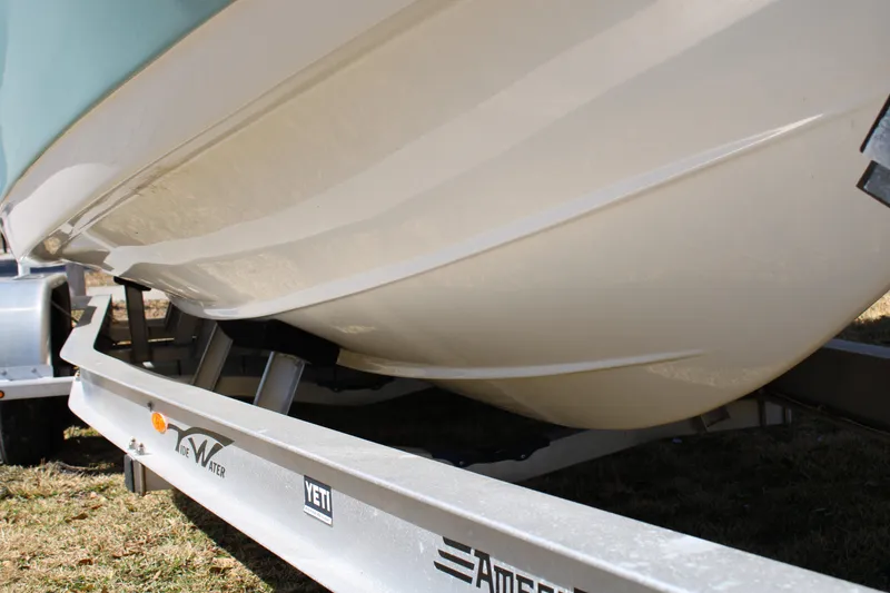 Slide: The Image of 2022 Tidewater 272 CC Adventure boat hull on trailer, close-up view. - 8