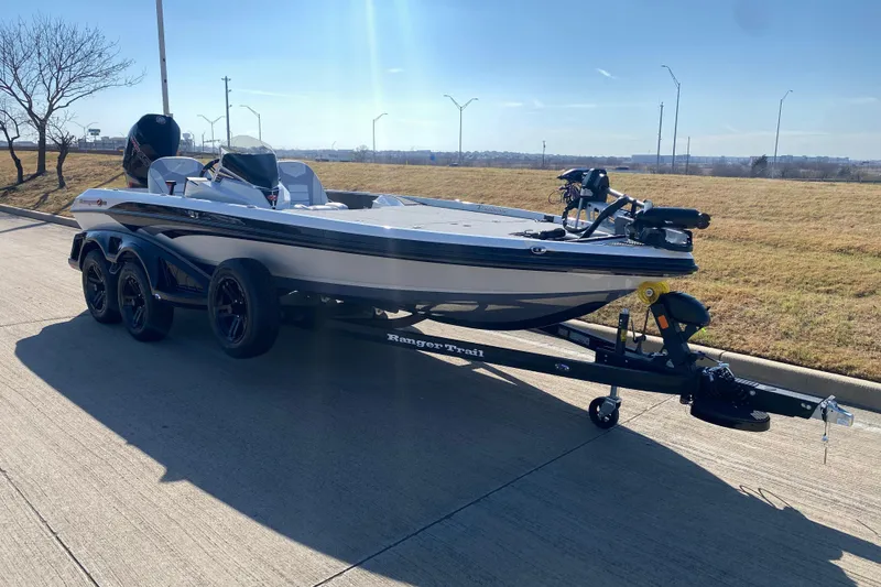 Slide: The Image of 2026 Ranger Z520 boat on trailer, parked on roadside under clear blue sky. - 4