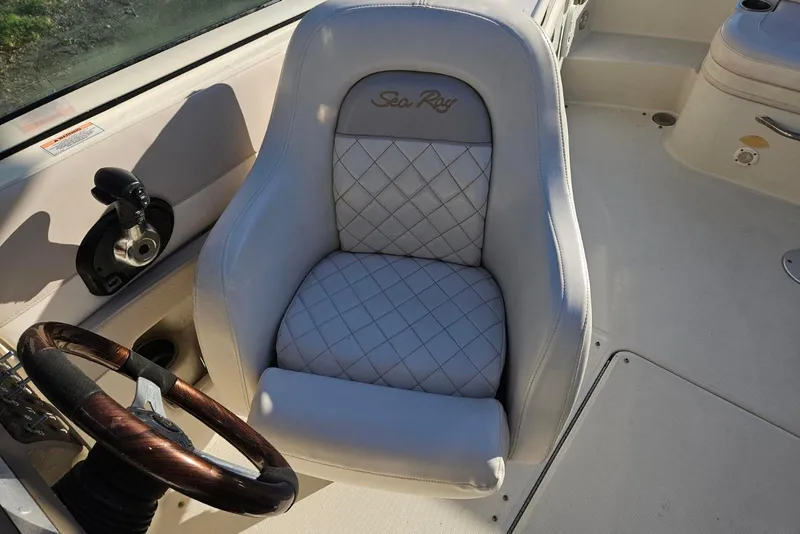Slide: The Image of Captain's seat of 2009 Searay 260 boat with quilted upholstery and steering wheel. - 9