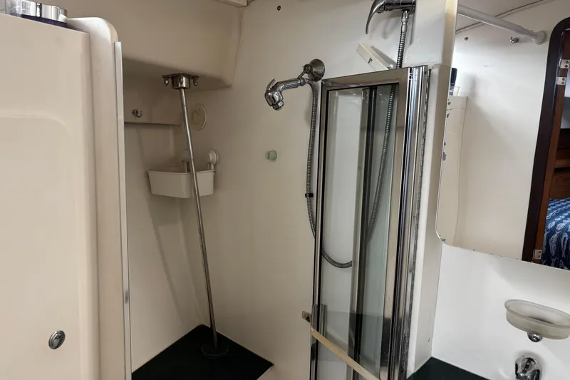 Slide: The Image of Bathroom interior of a 2005 Catalina Morgan 440 yacht, featuring a shower and sink. - 11
