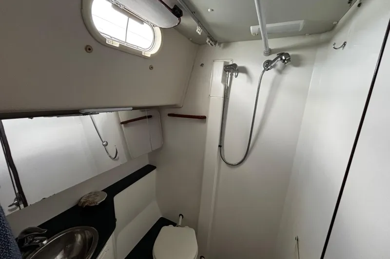 Slide: The Image of Compact bathroom in a 2005 Catalina Morgan 440 yacht, featuring shower and toilet. - 14