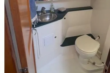 Slide: The Image of 2005 Catalina Morgan 440 yacht bathroom with sink, toilet, and storage. - 15