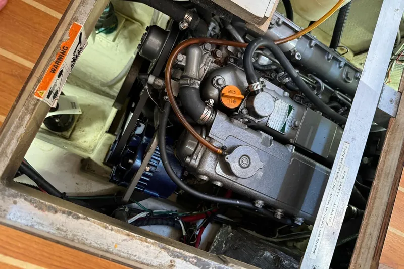 Slide: The Image of Engine compartment of a 2005 Catalina Morgan 440 sailboat, showcasing mechanical components. - 16