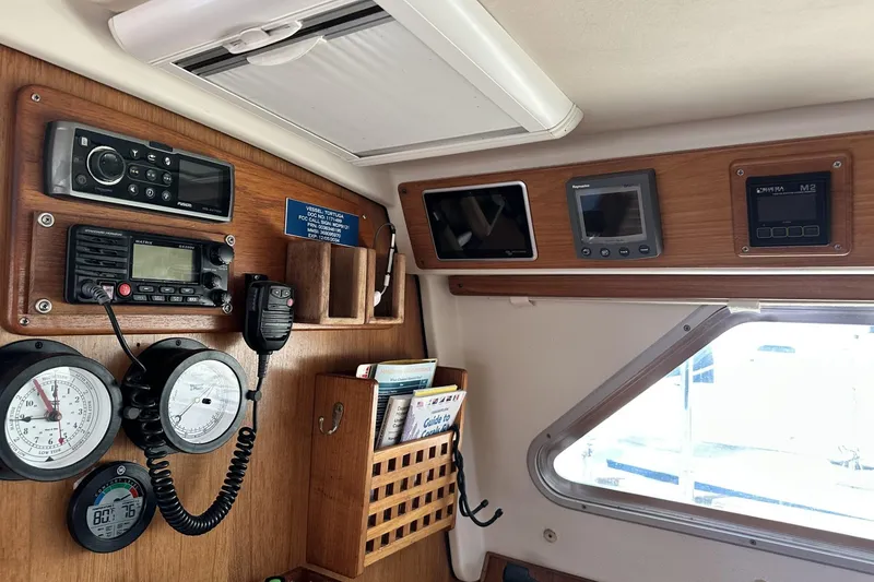 Slide: The Image of Navigation and communication equipment inside a 2005 Catalina Morgan 440 sailboat cabin. - 21