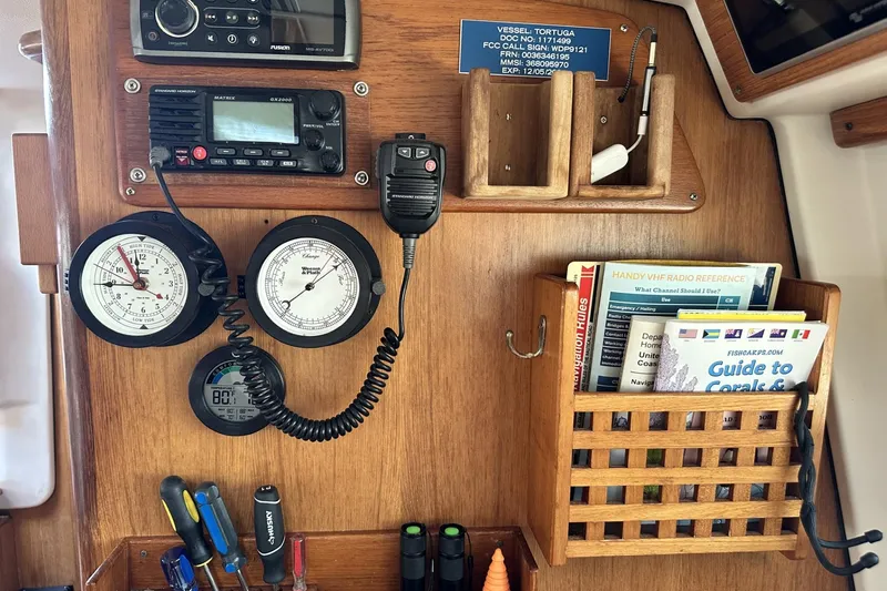 Slide: The Image of Navigation station on a 2005 Catalina Morgan 440 sailboat with instruments and manuals. - 22