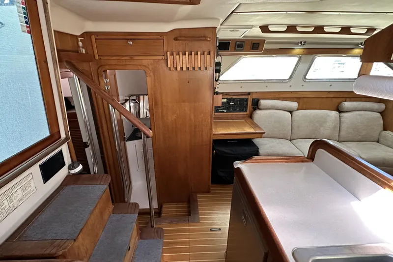 Slide: The Image of Interior of 2005 Catalina Morgan 440 yacht with wooden finishes and cozy seating area. - 23