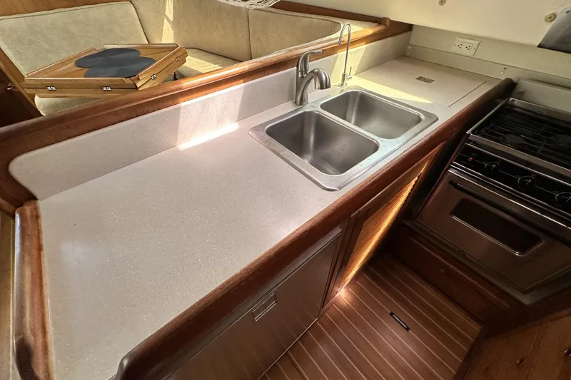 Slide: The Image of 2005 Catalina Morgan 440 yacht kitchen with dual sinks and stove. - 29